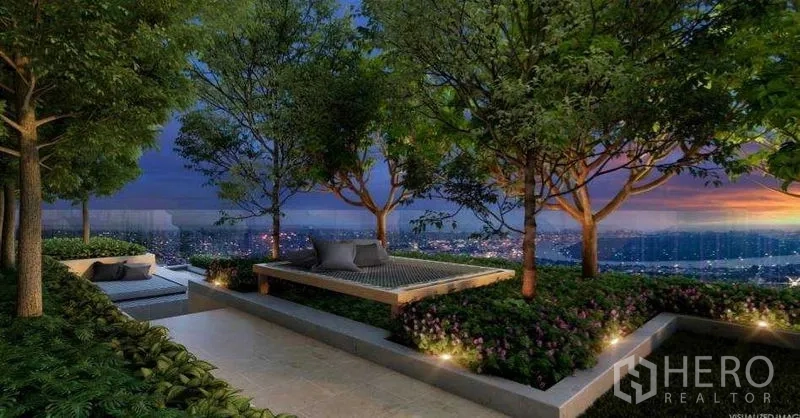 Condominium for sale in Sathon, Bangkok - Rooftop garden terrace with trees, seating nooks, and sunset views over the city.