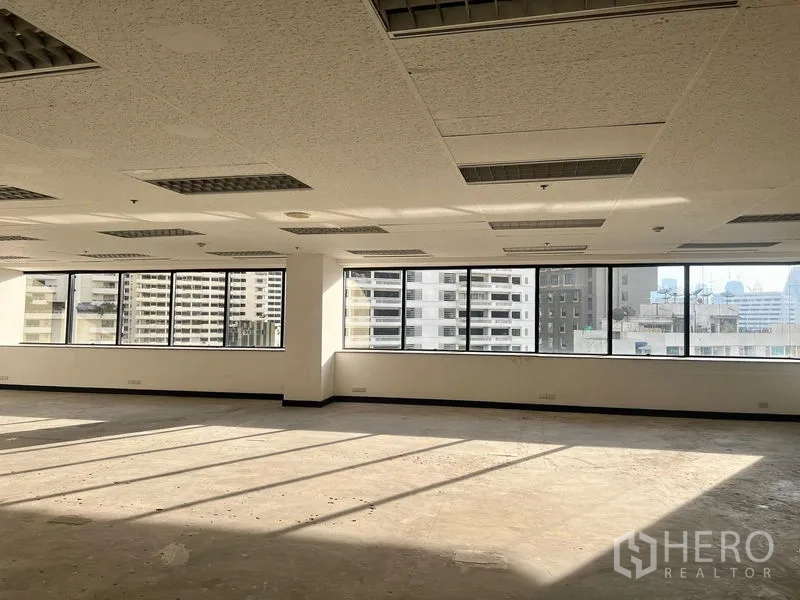 Office Space for rent in Khlong Toei, Bangkok - Corner office space with panoramic windows flooding natural light across an unfurnished floor.