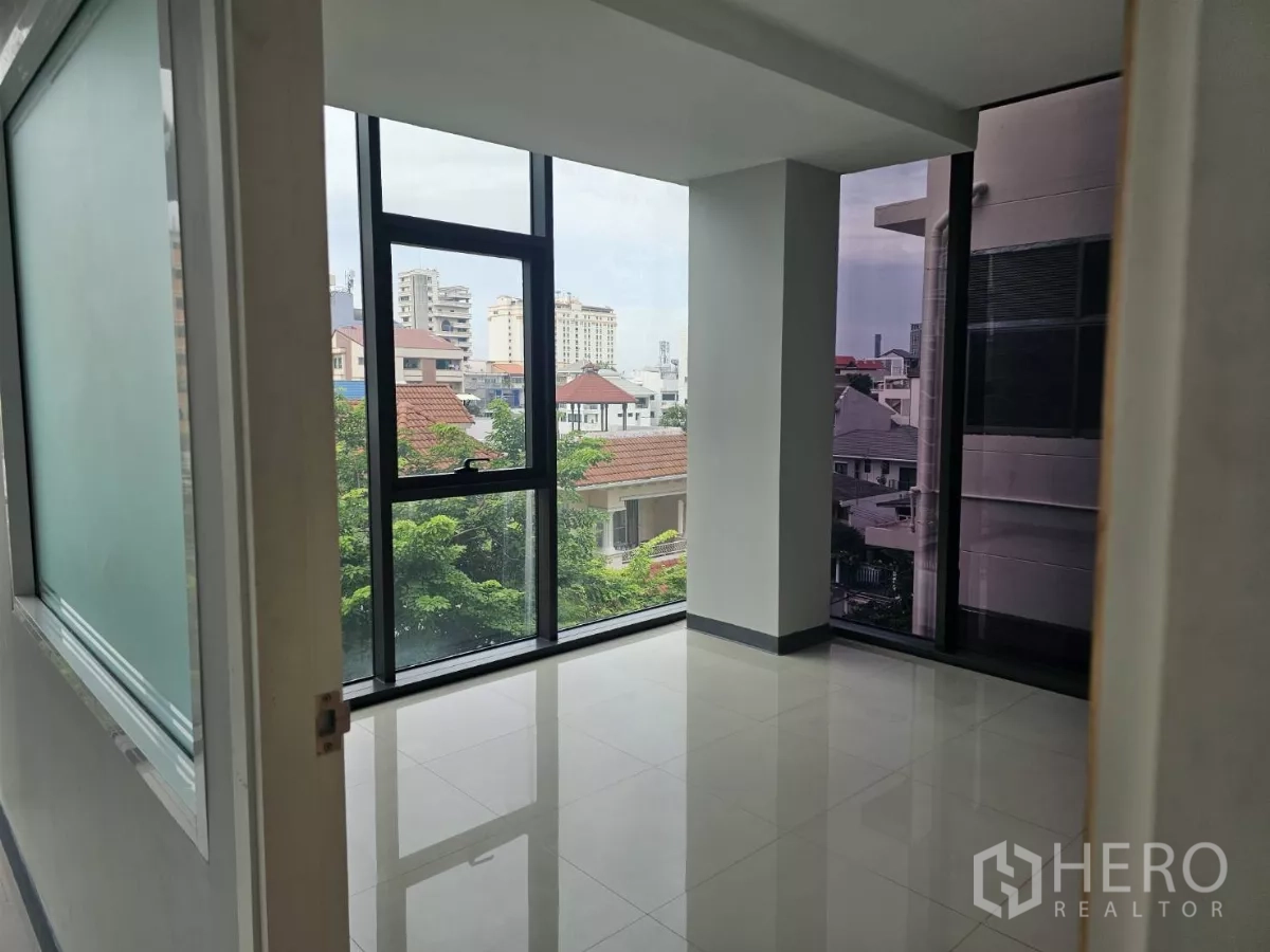 Office Space for rent in Sathon, Bangkok - Small meeting room or manager’s office with corner windows, frosted glass and tree-top outlook.