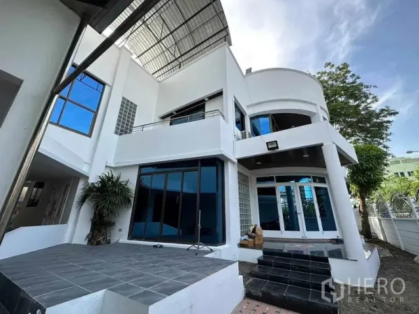 Home Office for sale - Modern white home office exterior with large glass doors, tiled terrace and steel canopy in Wang Thonglang, Bangkok.