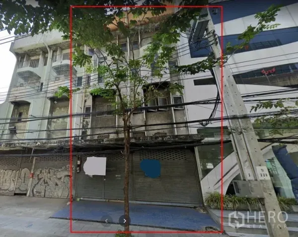 店屋 出租在Bang Na, Bangkok - 临街多层店屋外立面，金属卷闸门、人行道与电线可见