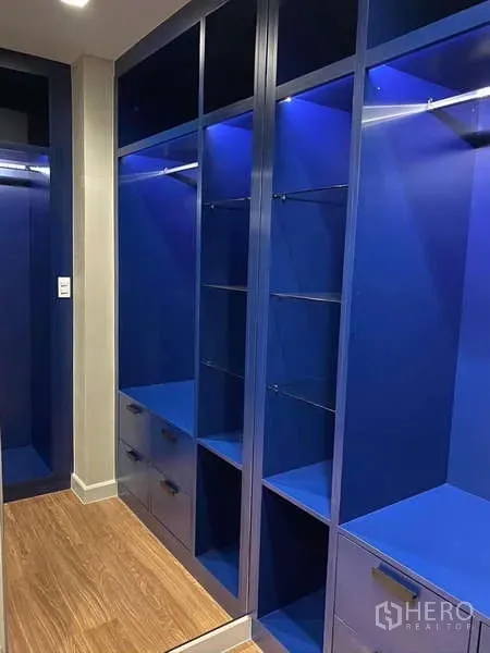 Detached House for rent - Walk-in closet featuring blue built-in wardrobes with LED accent lighting.