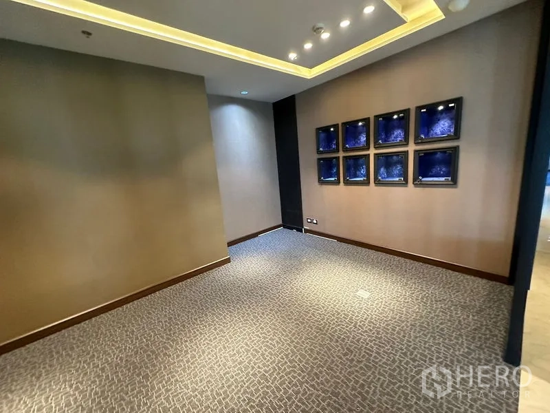 Office Space for rent - Breakout corner with accent wall displays, cove lighting and carpet flooring.