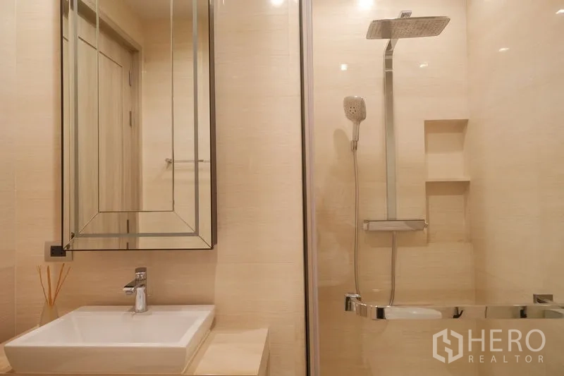 Condominium for rent or sale in Watthana, Bangkok - Bathroom with glass shower enclosure, rain shower head and square basin vanity.