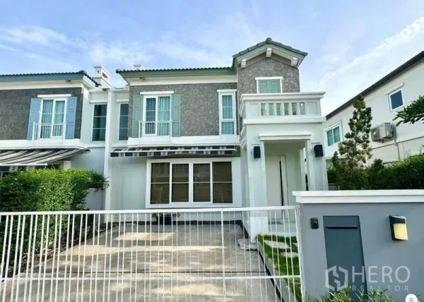 Detached House for rent or sale in Prawet, Bangkok - Another front exterior view highlighting gated parking and second-floor balcony.