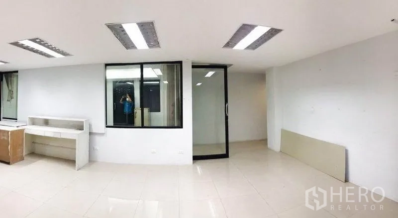 Office Space for rent or sale in Don Mueang, Bangkok - White-tiled office area with glass partition and sliding glass door, plus a built-in counter.