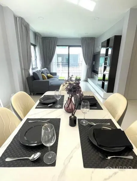 Detached House for rent - Dining area with marble-top table set for four in an open-plan space beside the living room.