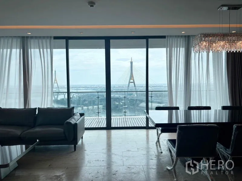 Condominium for rent - Living room opening to a balcony with Bhumibol Bridge views.