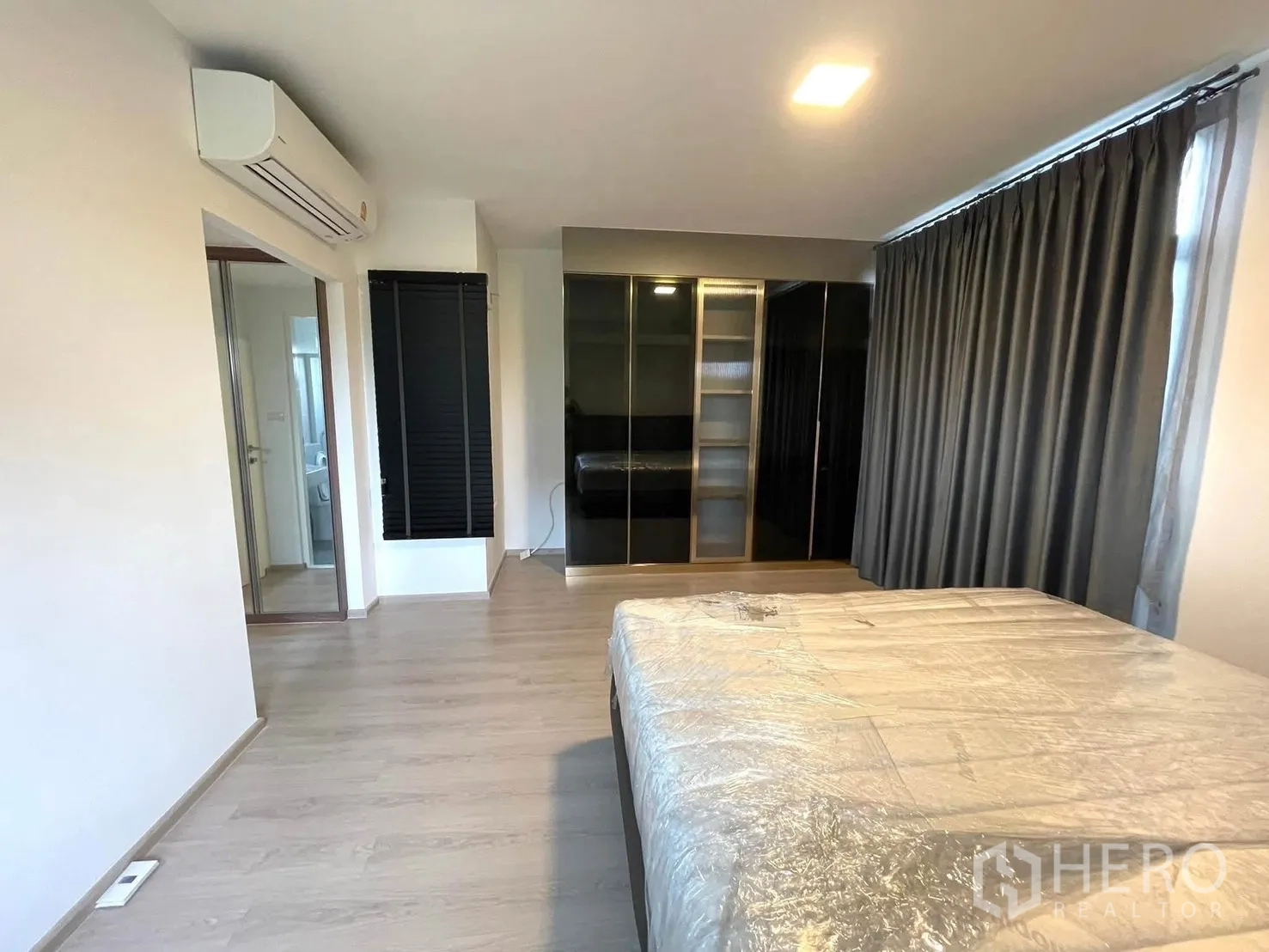 Townhouse for rent in Bang Phli, Samut Prakan - Spacious master bedroom with bed, wardrobes and large windows.