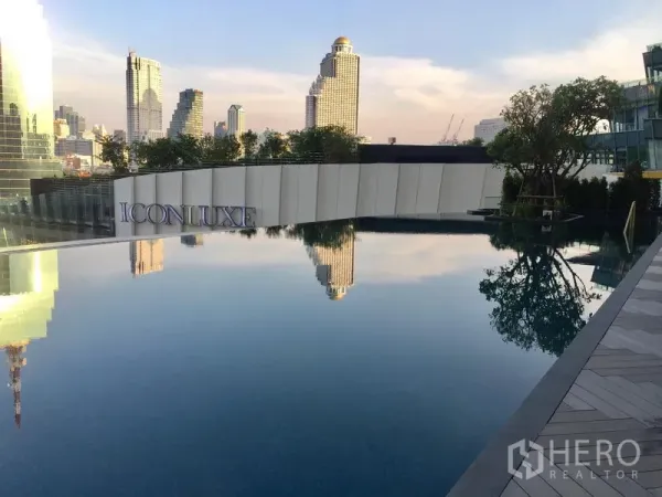 Condominium for sale in Khlong San, Bangkok - Riverside infinity-edge pool at ICONLUXE with reflections of the Bangkok skyline.