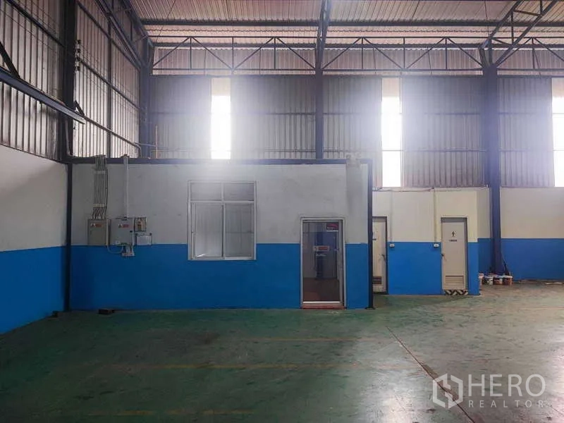 Warehouse for rent in Si Racha, Chon Buri - Internal office rooms with electrical panels and staff facilities inside the warehouse.