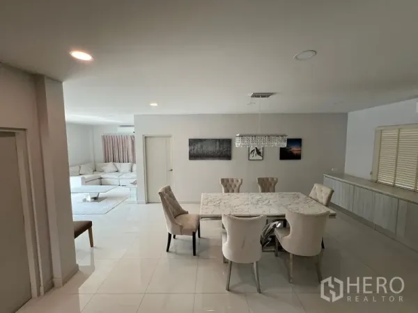 Detached House for rent in Bang Phli, Samut Prakan - Open-plan dining and living area with marble table and neutral decor.