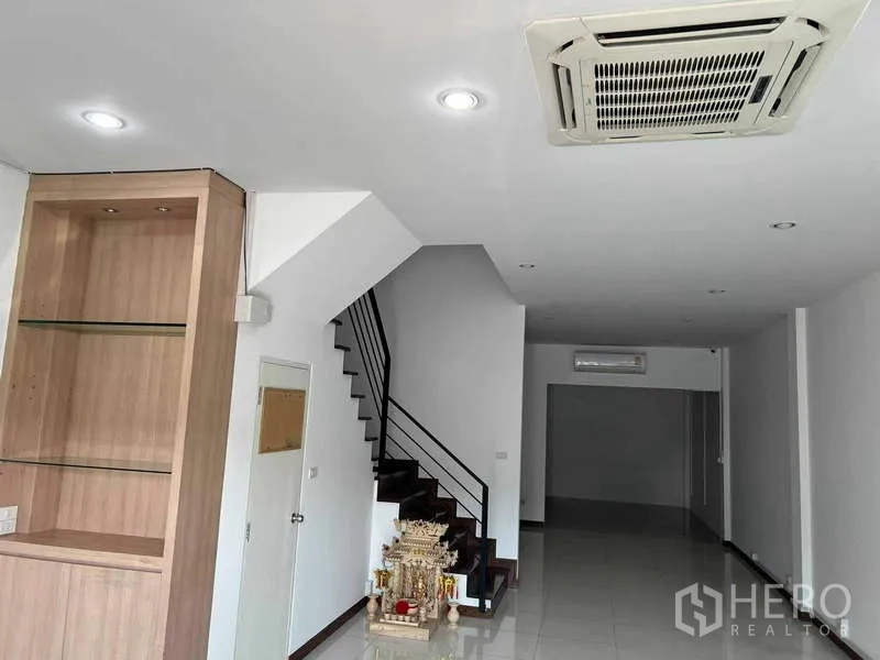 Home Office for rent in Bueng Kum, Bangkok - Long reception and workspace with built-in display cabinet, ceiling cassette AC and staircase.