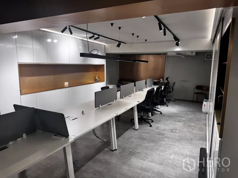 Office Space for rent or sale in Suan Luang, Bangkok - Open-plan workstation row with track lighting, window blinds and storage cabinets.