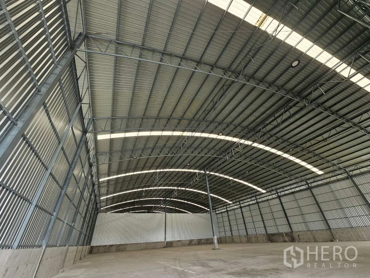 คลังสินค้า ให้เช่าในLam Luk Ka, Pathum Thani - มุมมองหลังคาเหล็กทรงโค้ง พร้อมแผ่นโปร่งแสงและโครงทรัสภายในโกดัง