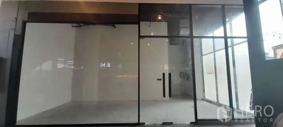 Retail Space for rent - Empty retail shopfront with full-height glass facade, double glass doors, white walls and concrete floor ready for fit-out in Sathon, Bangkok.