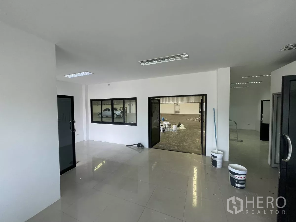Warehouse for rent in Lat Krabang, Bangkok - Reception-style office space with windows overlooking the warehouse floor.