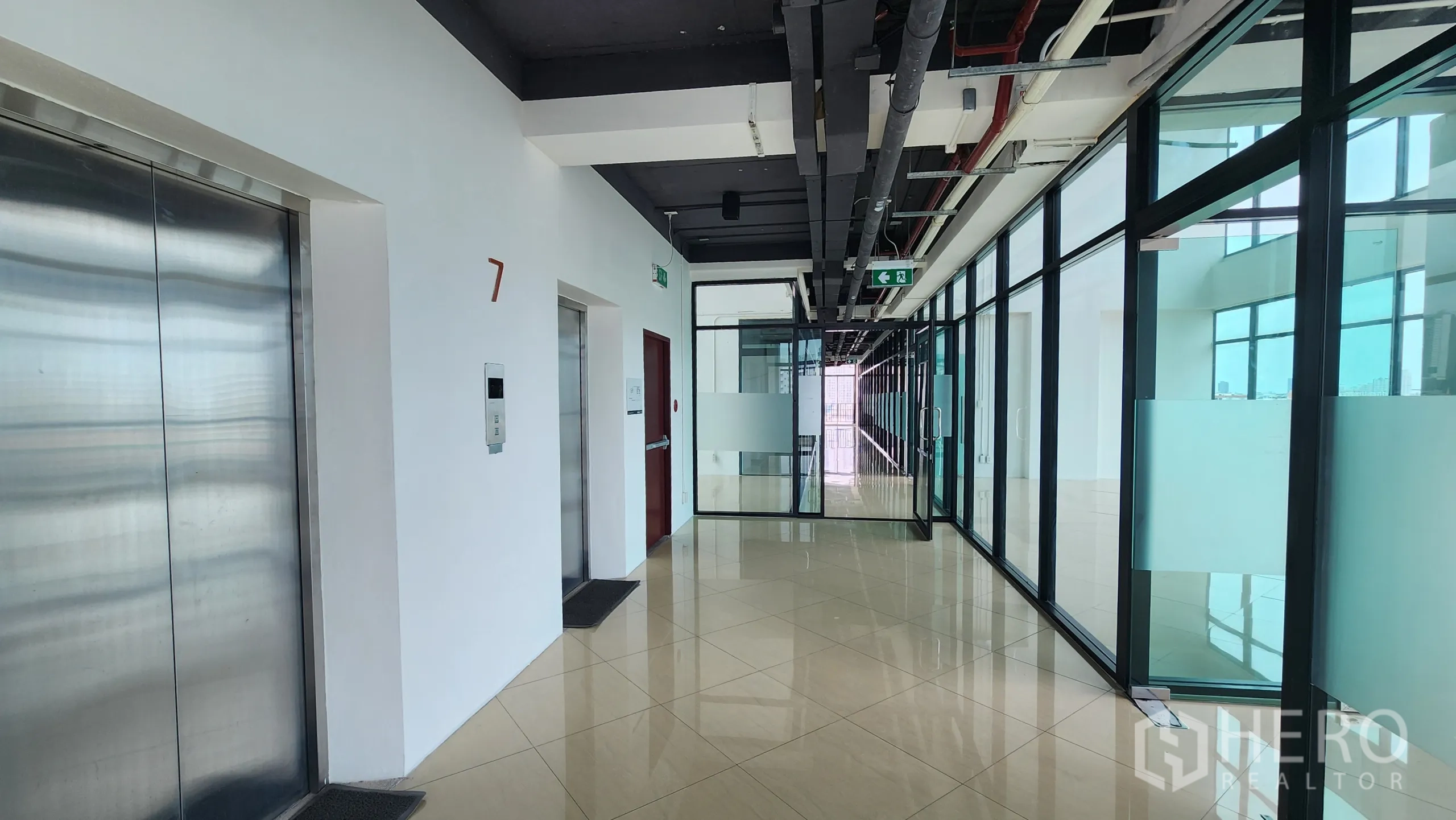 Office Space for rent in Yan Nawa, Bangkok - Corridor by elevators on level seven with glass doors to office units.