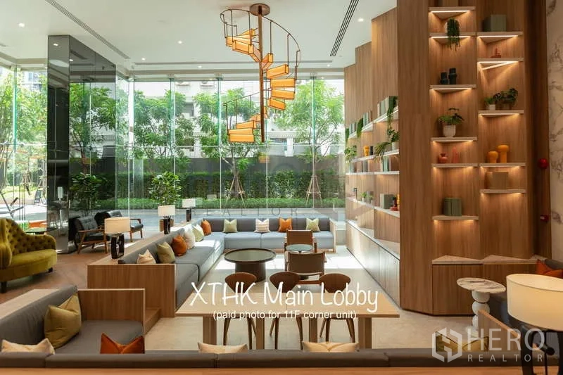 Condominium for rent or sale - Bright main lobby with ample seating, shelving wall and sculptural chandelier.