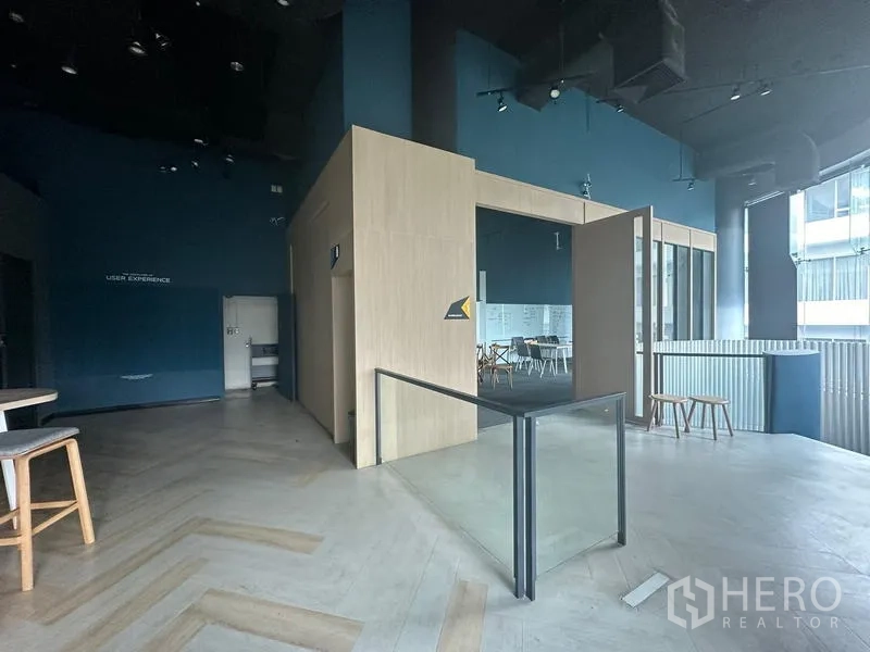 Office Space for rent - Entrance to meeting room clad in light wood with glass partition and railing around stair opening.