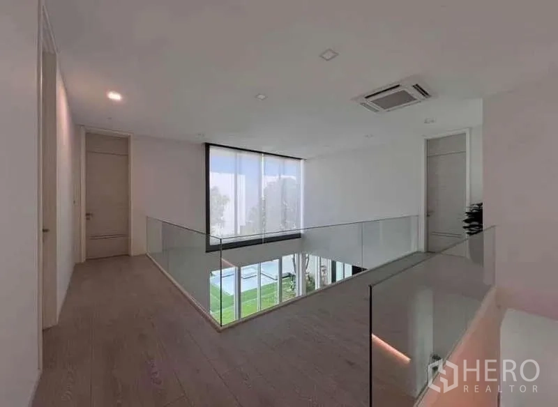 Detached House for sale in Bang Phli, Samut Prakan - Upstairs landing with glass balustrade overlooking the living room and garden.