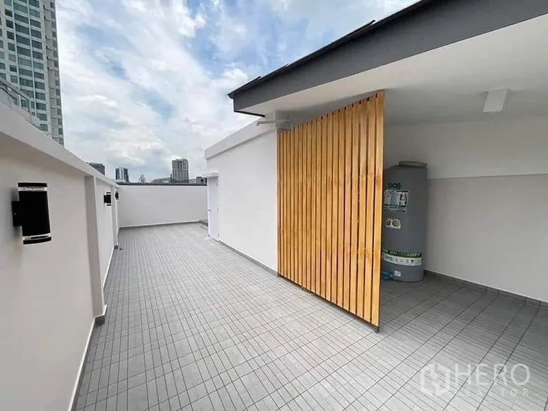 Townhouse for sale in Watthana, Bangkok - Rooftop deck with tiled flooring and utility area screened by wooden slats, city views.
