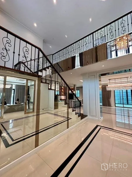Detached House for sale - Staircase with wrought-iron balustrade overlooking a glossy tiled hall.