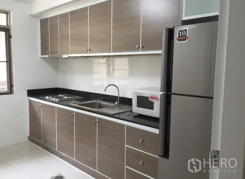 คอนโด ให้เช่าหรือขายในWatthana, Bangkok - ครัวแบบแกลลีย์ ตู้ลายไม้ เคาน์เตอร์หินสีดำ อ่างล้างคู่ เตาไมโครเวฟ และตู้เย็นขนาดใหญ่