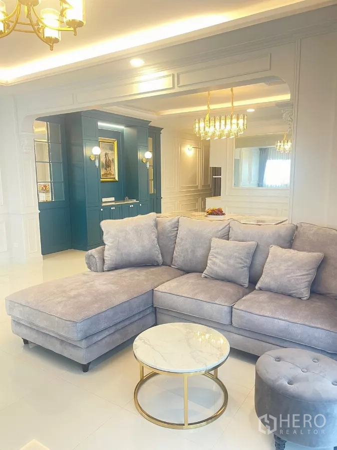 Detached House for rent in Bang Phli, Samut Prakan - Main living room with gray L-shaped sofa and round marble coffee table.