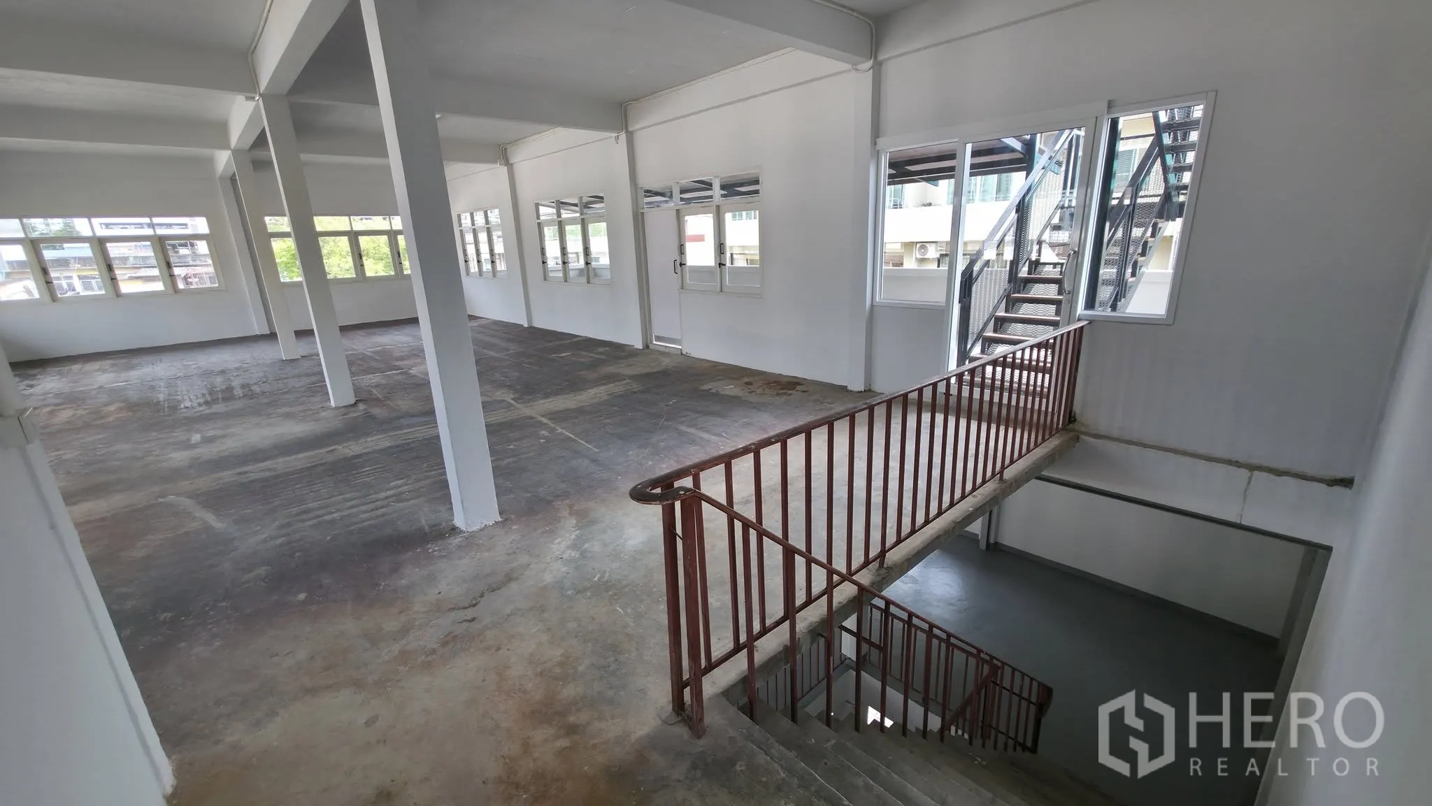 โกดัง for rent in Din Daeng, Bangkok - ชั้นโกดังที่เห็นบันไดภายใน หน้าต่างบานใหญ่ และทางออกสู่บันไดภายนอก