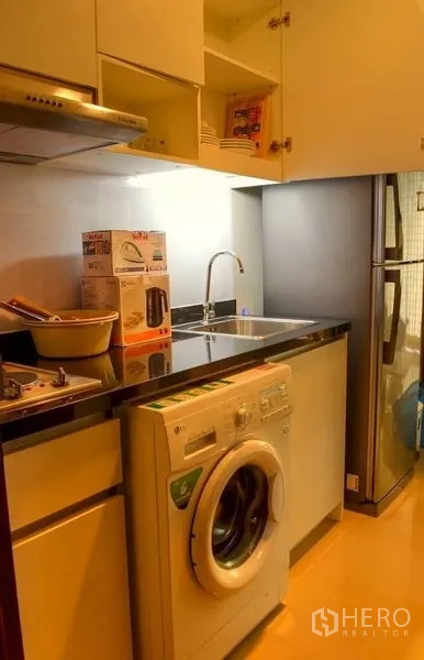 คอนโด ให้เช่าในPhaya Thai, Bangkok - ครัวยุโรปขนาดกะทัดรัด เคาน์เตอร์สีดำ ซิงก์ เครื่องซักผ้า และตู้เย็น