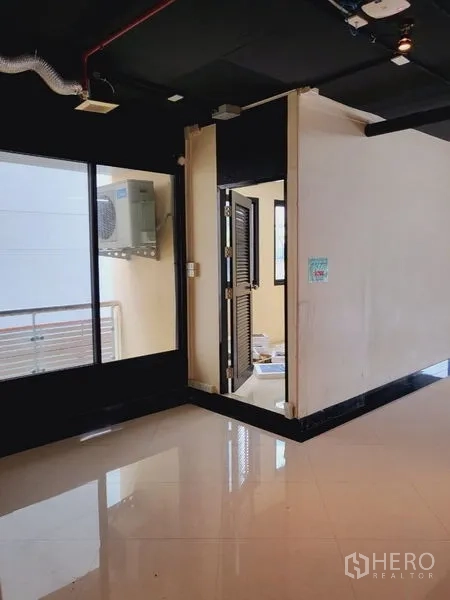 办公空间 出租在Khlong Toei, Bangkok - 办公走道，带玻璃窗与通往功能房的门。
