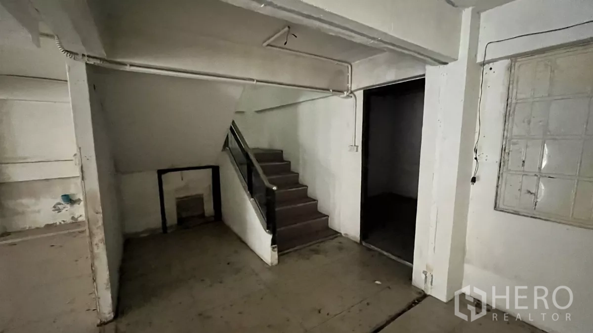 店屋 出租在Watthana, Bangkok - 一层楼梯与楼梯下储物区的店屋空间。