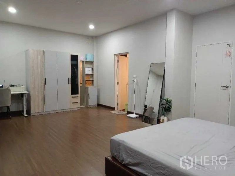บ้าน ให้เช่าในMueang Nonthaburi, Nonthaburi - ห้องนอนกว้างพร้อมตู้เสื้อผ้า โต๊ะทำงาน และประตูห้องน้ำในตัว พื้นไม้