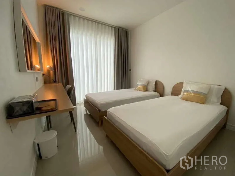 บ้าน ให้เช่าในLat Krabang, Bangkok - ห้องนอนอบอุ่น เตียงเดี่ยวสองเตียง ผ้าม่านทึบแสง และโต๊ะทำงานยาว