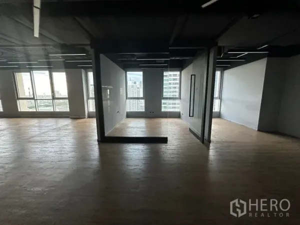 Office Space for rent in Bang Rak, Bangkok - Semi-partitioned workspace with city views and wood floors in a high-rise office.