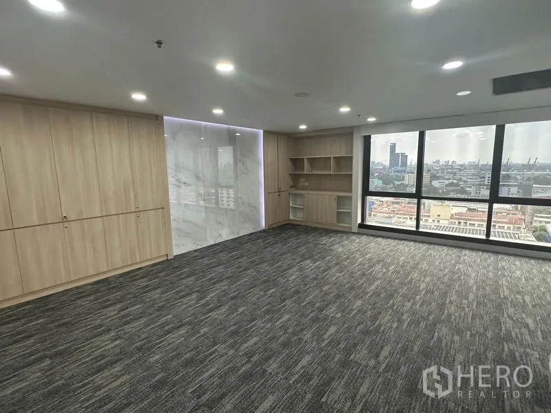 Office Space for rent in Khlong Toei, Bangkok - Executive boardroom-style space with wood cabinetry, marble accent wall, and skyline view.