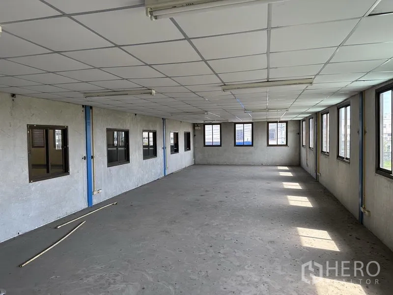 货栈 出租在Bang Phli, Samut Prakan - 另一处明亮办公间，格栅吊顶与侧窗环绕，水泥地面。
