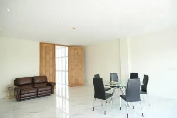 Home Office for rent or sale in Prawet, Bangkok - Open-plan living and dining area with marble floors, leather sofa and glass dining set.