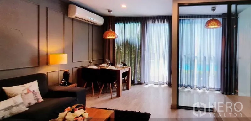 Condominium for rent in Phra Khanong, Bangkok - Bright living and dining area with floor‑to‑ceiling windows and pool view.