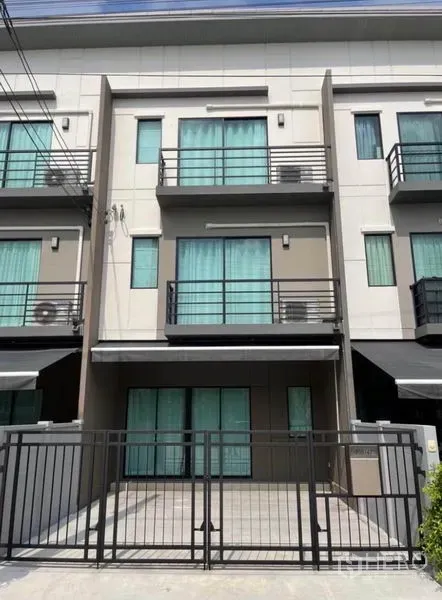 Townhouse for rent in Phasi Charoen, Bangkok - Three-storey modern townhouse exterior with gated parking and balconies.