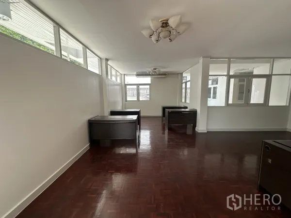Home Office for rent in Watthana, Bangkok - Bright open-plan office with parquet wood floors, windows and several desks.