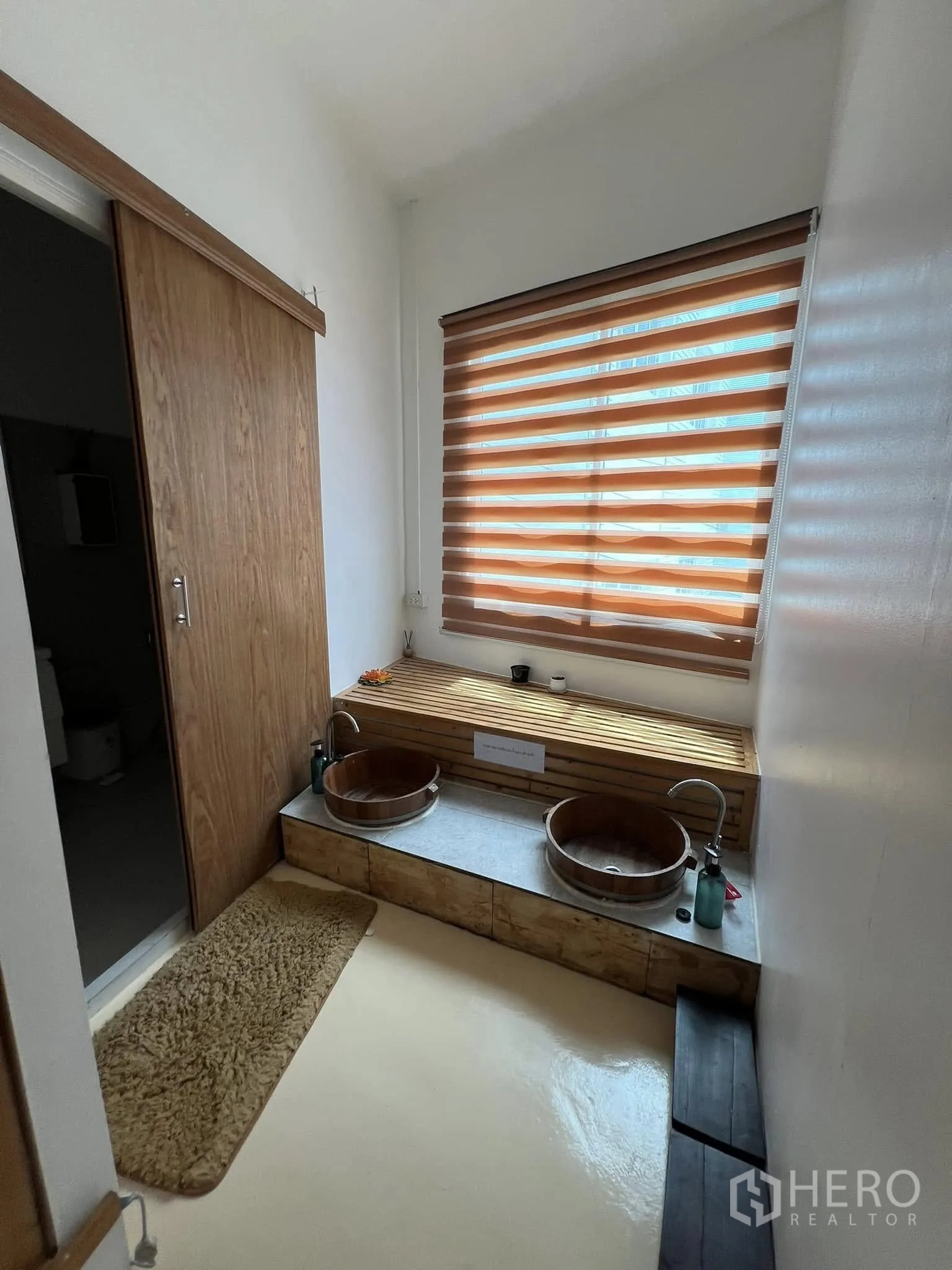 Retail Space for rent in Lat Phrao, Bangkok - Twin wooden foot-bath bowls set below a window with blinds.
