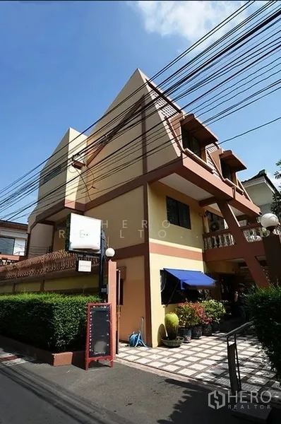 บ้าน ให้เช่าในWatthana, Bangkok - บ้านเดี่ยวสามชั้นทรงเหลี่ยมในเขตวัฒนา มีระเบียง กันสาด และทางเข้าปูกระเบื้องริมซอยเงียบ