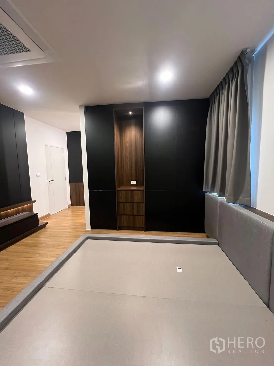 Detached House for rent in Bang Phli, Samut Prakan - Bedroom with platform bed, built-in closet and warm wood floors.