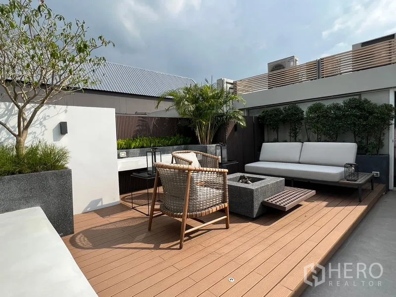 联排别墅 出售在Lat Phrao, Bangkok - 屋顶露台，铺设木地板，户外沙发与绿植