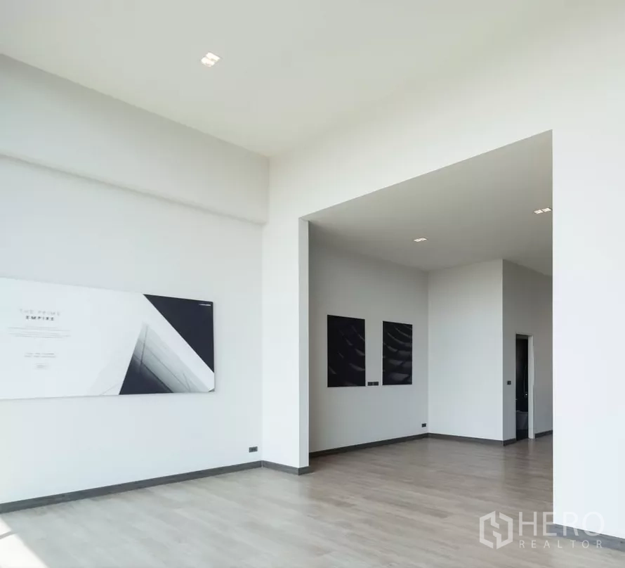 Home Office for sale in Bang Kapi, Bangkok - White-walled open room with wood flooring and doorway to a bathroom.