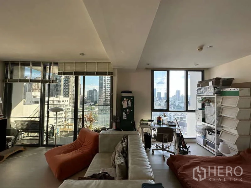 Condominium for rent - Open-plan lounge with sectional sofa, bean bag and large windows to the balcony.