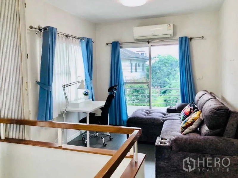 Detached House for rent or sale - Upstairs family area with desk, grey sectional sofa and balcony view.