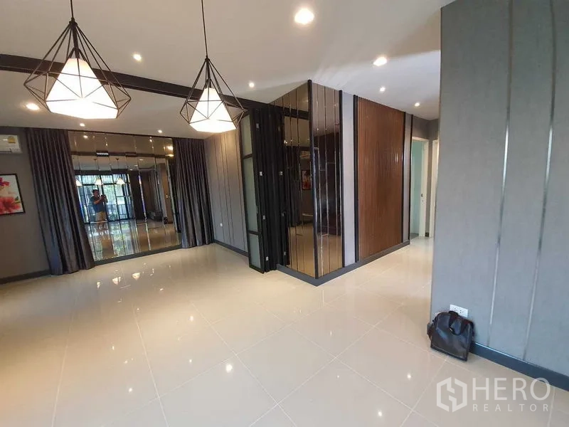 Detached House for sale in Bang Khun Thian, Bangkok - Spacious multipurpose room with glossy tiles, geometric pendant lights and feature walls.